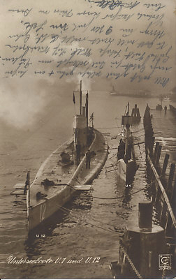 German submarines U.12 and U.1 tied up at the dock. U.1 (commissioned 1906) was the first German submarine. U.12 (commissioned 1911) was sunk off Eyemouth, Scotland, in 1915.
Text:
Unterseeboote U.1 und U.12
Submarines U.1 and U.12