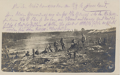 German soldiers on the San River in Russia on July 17, 1916. The river flows beyond the trees in the distance.
Text, a short translated part of the writing on the front side: 'From the trenches Jul 17 1916 — a small view from our trenches. Above the dam behind the forest there is the San river. Beside there are many fishermen and smokehouses. It's said that there have been made 50 tons of smoked fish each year.' Translation courtesy of Thomas Faust, eBay's Urfaust.