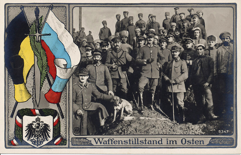 Postcard celebrating the ceasefire on the Eastern Front. The troops are Russian, Austro-Hungarian, and German. The flags are Austrian and Russian; the coat of arms and bunting German. Russia declared a ceasefire on December 15, 1917. The Treaty of Brest-Litovsk, ending Russia's involvement in the war, was signed on March 3, 1918 between Russia and the Central Powers.
In the foreground, a dog scowls at the photographer.
Text:
Waffenstillstand im Osten
Ceasefire in the East

Logo NPG (?) B347

Reverse:
Lines only