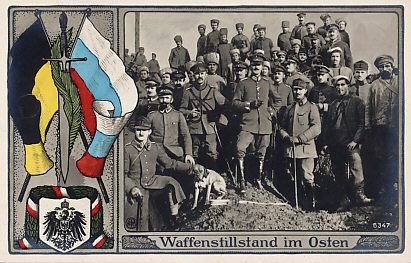 Postcard celebrating the ceasefire on the Eastern Front. The troops are Russian, Austro-Hungarian, and German. The flags are Austrian and Russian; the coat of arms and bunting German. Russia declared a ceasefire on December 15, 1917. The Treaty of Brest-Litovsk, ending Russia's involvement in the war, was signed on March 3, 1918 between Russia and the Central Powers.
In the foreground, a dog scowls at the photographer.
Text:
Waffenstillstand im Osten
Ceasefire in the East

Logo NPG (?) B347

Reverse:
Lines only