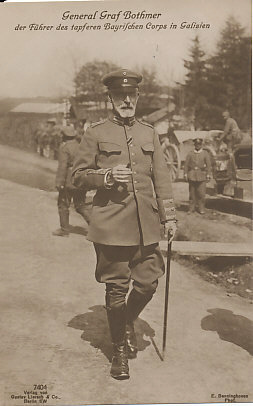 Full-length portrait photograph of General Felix Graf von Bothmer walking with a walking stick in his left hand, and a cigar in his right. Troops in the background. Photograph by E. Benninghoven, published by Gustav Lierach & Co., Berlin SW.
Text: General Graf Bothmer, Führer des tapferen Bayrischen Corps in Galizien — General Count Bothmer, leader of the brave Bavarian Corps in Galicia
7404 Verlag von Gustav Lierach & Co., Berlin SW
E. Benninghoven Phot.
Reverse: registration lines only