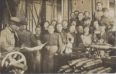 Women workers in a German munitions factory. The man on the right is holding a cigarette.