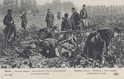 Belgian soldiers preparing a Hotchkiss machine gun position in a field. A line of troops is visible in the background. Like other attackers throughout the war, the Germans suffered heavy losses attacking positions defended by machine guns.
Text:
1914... Armée Belge - Installation d'une mitrailleuse nouveau modele
Belgian Army - Getting a new model quick firer ready
10me Série
Logo: BLD