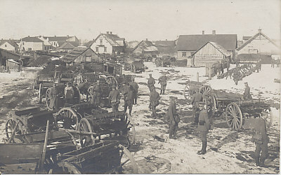 German soldiers in a Russian village. The message is dated, and the card field postmarked May 3, 1918. The men's packs and rifles are laid out in the right background; horses can be seen in the left background.