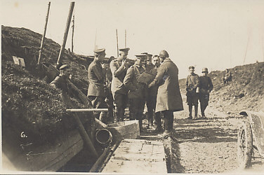 An aerial observer or pilot in flight helmet and overcoat reports to a German General and his staff at a division's combat headquarters on March 21, 1918, the first day of Operation Michael, Germany's spring offensive, the first of five German drives in 1918.
Text:
Reverse (handwritten):
21. 3. 18.
Division Combat HQ
