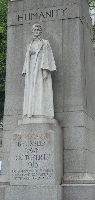 Memorial statue to Edith Cavell, executed for helping British soldiers in %+%Location%m%15%n%Belgium%-% reach neutral %+%Location%m%65%n%Netherlands%-%. She was executed by firing squad in Brussels, Belgium on October 12, 1915.
Sited in St. Martin's Place, London, the pedestal on which her statue stands is placed before a column, square at the base and rounded above her head. On the four sides of the lower column are the words 'Humanity,' 'Sacrifice,' 'Devotion,' 'Fortitude.' The inscription on the front of the pedestal reads:
'Edith Cavell
Brussels Dawn October 12th 1915
Patriotism is not enough. I must have no hatred or bitterness for anyone.'
The quotation is from her conversation with the English chaplain, Mr. Gahan, who was with her before her execution.
At the top of the column a mother and child replace the top of a cross. Below them is a shield reading 'For King and Country.'
The memorial was designed by Sir George Frampton.