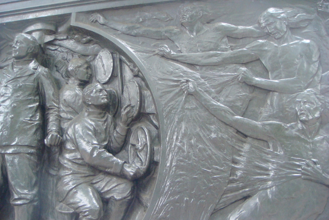 Detail from the National Submarine War Memorial on the Embankment in London, United Kingdom: the submariners manning the machine and some of the forces seeking its destruction. The Memorial lists the British submarines lost in the World Wars I and II.