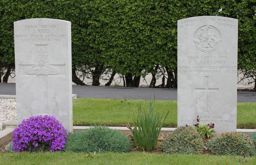 Headstones from Martinpuich Cemetery, Martinpuich, France: for J. Reid of the Royal Field Artillery, died October 6, 1916, and R.E. Bullows of the Royal Warwickshire Regiment, died November 11, 1916. Martinpuich was in the Somme sector.
Text:
54766 Driver
J. Reid
Royal Field Artillery
6th October 1916
Known to be Buried in this Cemetery
3009 Lance Cpl.
R.E. Bullows
Royal Warwickshire Rgmt.
11th November 1916 Age 22
Greater love hath no man than this